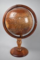 A Late 20th Century Naive Carved Wooden Table-top Globe, 43cm High