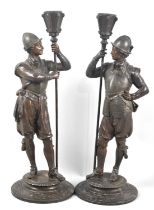 A Pair of Early 20th Century Continental Bronze Effect Figural Candlesticks in the Form of