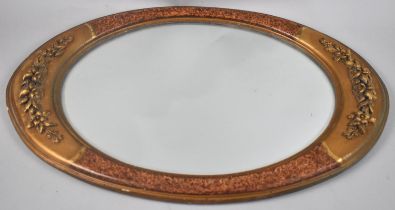 A Modern Wall Hanging Oval Wall Mirror with Relief Floral Swag Decoration, 53cms by 35cms