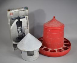 Two Plastic Chicken Feeders together with an Air Hammer Pump