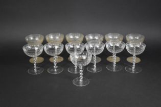 A Set of Thirteen Glass Coupes with Twisted Stem on Circualr Foot, the Bowl Decorated with Etched