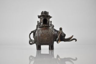 A Cast Chinese Bronze Censer in the Form of an Elephant with Pierced Pagoda Howdah Top, 14cms High
