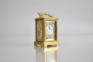 A Reproduction Miniature Gilt and Porcelain Panel Carriage Clock in the Sevres Style with Key and