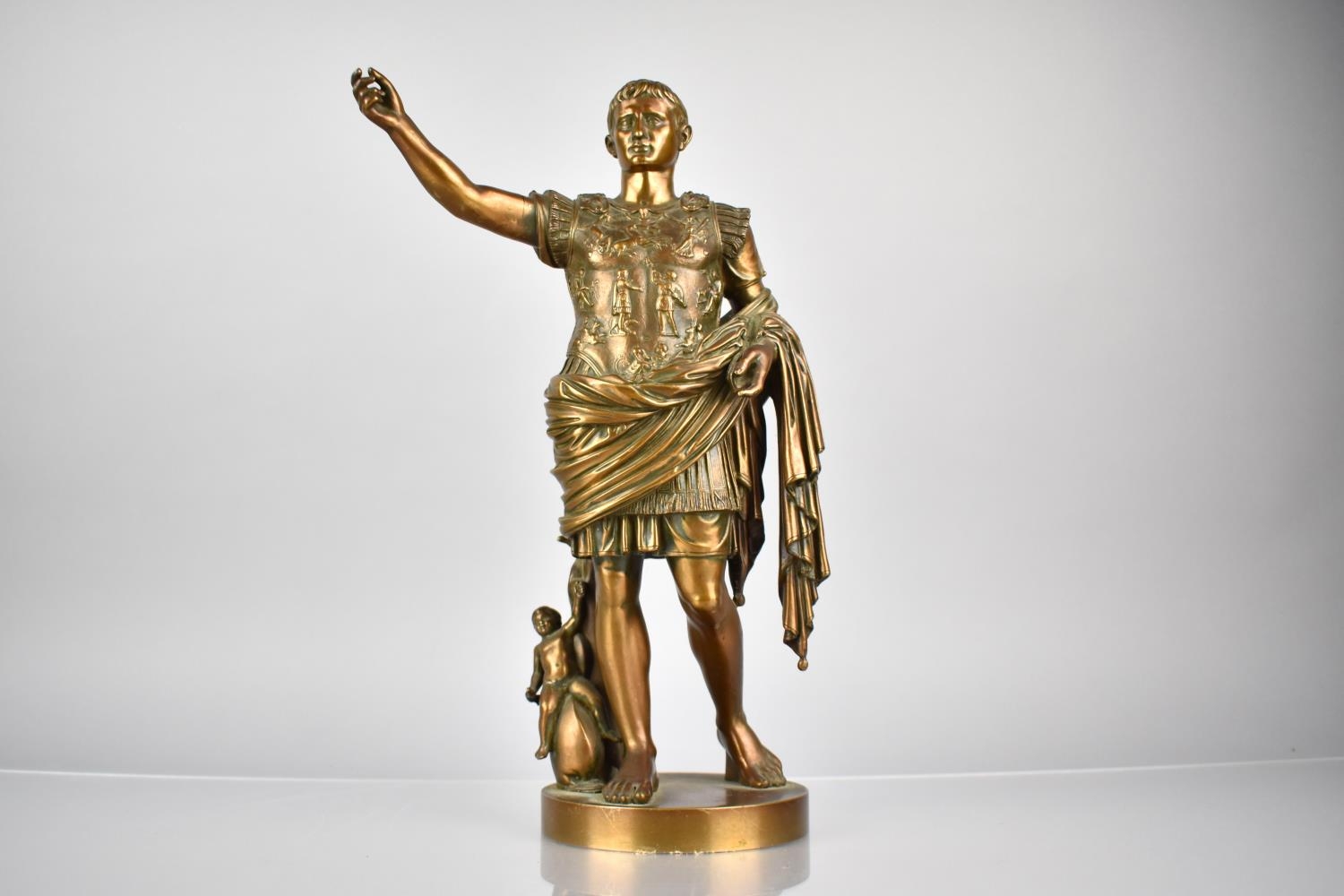 A Bronze Figure Of Augustus Caesar, Depicted with Arm Outstretched and with Putto by His Side,