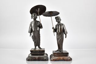 A Pair of Burmese Figures of Gent and Lady with Parasols, One Base Inscribed 'MG MYAI MANDALAY' on