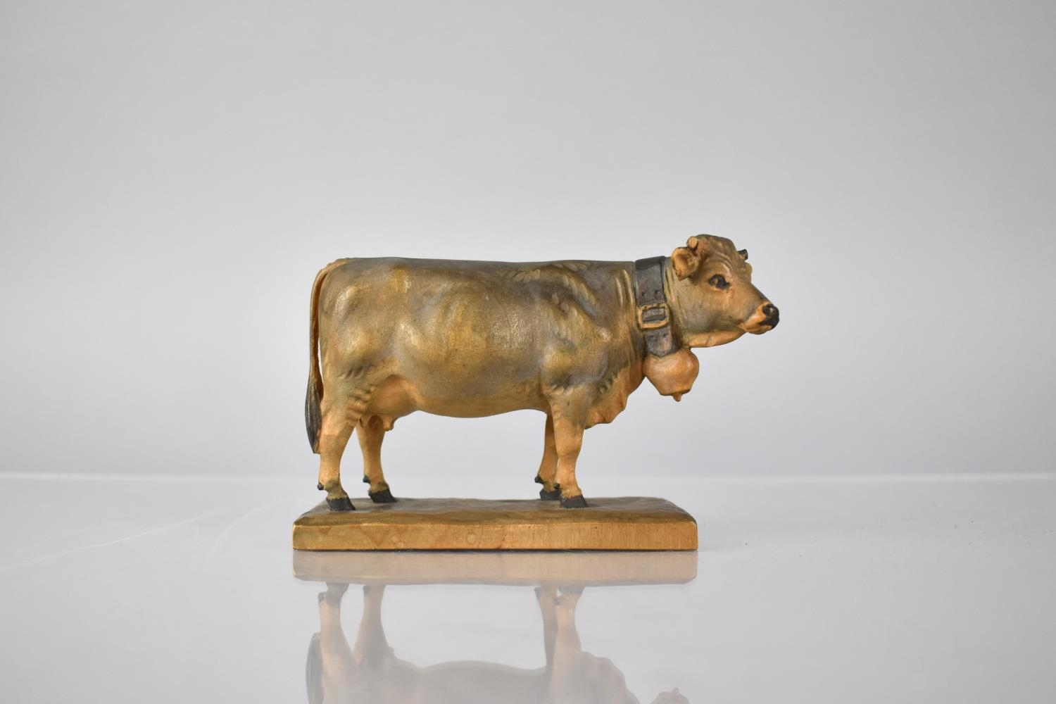 A Small Black Forest Carved Wooden Study of Milking Cow with Cowbell. Monogrammed HF to Plinth Base,