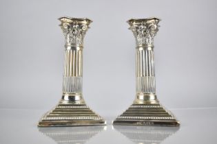 A Pair of Edward VII Silver Corinthian Column Candlesticks by Barker Brothers on Stepped Square