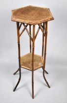 A Late 19th/20th Century Bamboo Rattan Octagonal Stand with Stretcher Shelf, 77cm High