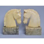 A Pair of Carved Alabaster Bookends in the Form of Horses Heads, 16cms High