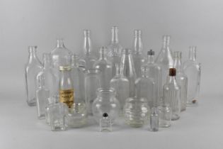 A Collection of Various Plain Glass Bottles