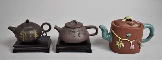 A Collection of Three 20th Century Yixing Teapots, Two with Stands