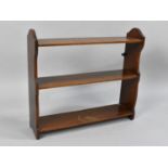 An Edwardian Mahogany Wall Hanging Three Shelf Unit, 59cms Wide