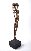 A Modern Bronzed Metal Sculpture of Figure Drinking From Bottle Beside Lamp Post. Set on Square
