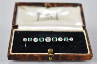 An Art Deco Diamond and Emerald Bar Brooch in White Metal, Central Round Cut Diamond Measuring 4.3mm