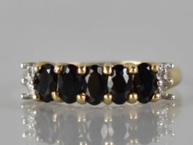 A 9ct Gold, Garnet and Diamond Ring to Comprise Five Oval Cut Stones (4.5mm by 3mm Approx), Claw Set