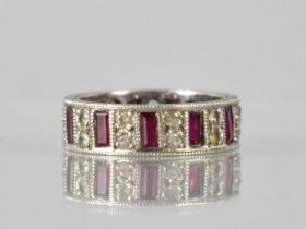 An Elizabeth II 9ct White Gold, Ruby and White Sapphire Eternity Ring, Eleven Baguette Cut Rubies