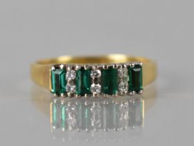 An Emerald and Diamond Ladies Dress Ring in 18ct Gold, Four Baguette Cut Emeralds Measuring approx