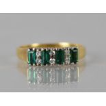 An Emerald and Diamond Ladies Dress Ring in 18ct Gold, Four Baguette Cut Emeralds Measuring approx