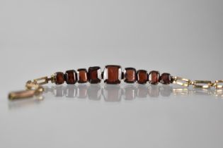 An Early 20th Century Gold Coloured Metal Bracelet Mounted with Nine Graduated Emerald/Cushion Cut