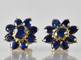 A Pair of Sapphire and Gold Coloured Metal Cluster Earrings, Central Claw Set Oval Cut Sapphire