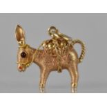 A French 18ct Gold Pendant in the Form of a Laden Donkey, Baskets Containing Two Simulated Pearls,