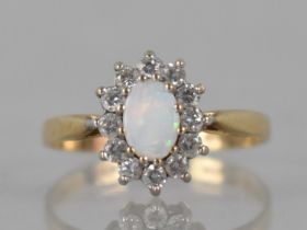 A 9ct Gold, Opal and CZ Ladies Dress Ring, Prong Set Central Oval Cabochon Plaque 6mm by 4mm with