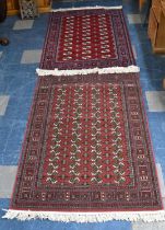 Two Patterned Rugs on Red Ground, 120x170cms