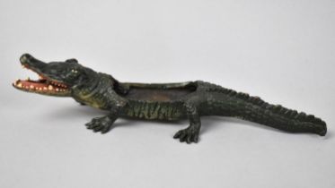 A Cold Painted Bronze Novelty Match Holder in the Form of a Crocodile, 22cms Long