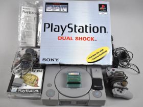 A Vintage Sony Dualshock Playstation with Two Controllers and Some Games, Not All Games Boxes