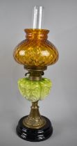 A Late Victorian Oil Lamp with Brass Support, Green Ceramic Reservoir, Coloured Shade and Plain