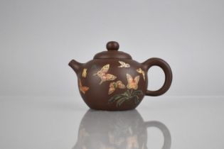 A Chinese Yixing Teapot Decorated with Applied Enamels Detailing Butterflies in Flight and