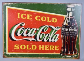 A Reproduction Printed Tin Metal Advertising Sign, "Ice Cold Coca-Cola Sold Here", 70x50cms