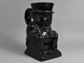 A Large Black Glazed Winston Churchill Jug, 30cm high