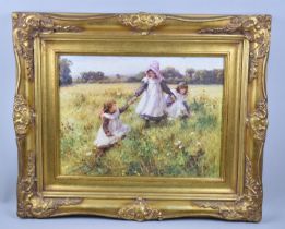 A Reproduction Gilt Framed Print Depicting Children Playing in Meadow, 39x29cms