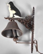 A Wall Hanging Cast Iron Bell decorated with Seated Border Collie, 38cms High