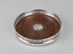 A Silver Plate and Wooden Bottle Coaster with Pierced Gallery, 13.5cms Diameter