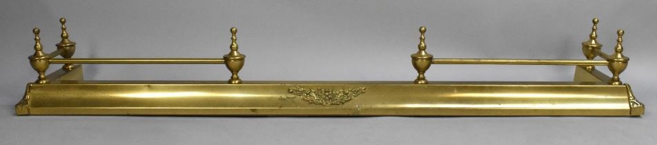 A Brass Fender Having Six Vase Final Bar Support and Central Scrolled Floral Motif