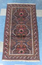 A Vintage Bokhara Type Pattern Rug on Burgundy Ground, 194x104cm