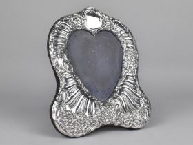 A Silver Photo Frame of Shaped Form Having Scrolled Foliates and Heart Shaped Opening, London
