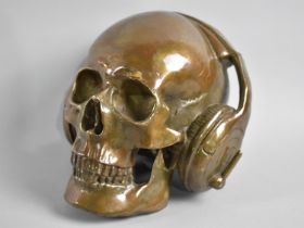 A Large and Heavy Bronze Effect Sculpture, Skull with Headphones, 16cms High