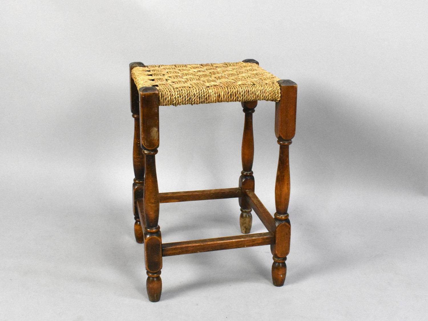 A Mid 20th Century oak Framed Rush Seated Square Topped Stool, 44cms High