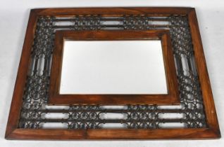 A Far Eastern Wooden and Wrought Iron Rectangular Wall Mirror, 100cms by 80cms