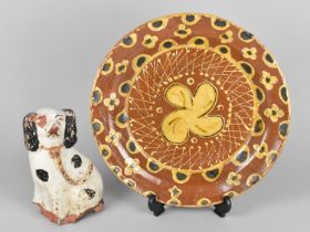 A Pottery Slip Glazed Dish Decorated with a Floral Motif, 30cm Diameter Together with a Late 19th/