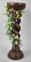 A Carved Wooden Open Spiral Plant Stand Decorated with Artificial Flowers and Fruit, 48cms High