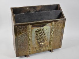 A Mid 20th Century Brass Two Division Magazine Rack with Pressed Galleon Decoration to Front