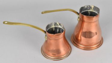 Two Graduated Copper Side Pouring Jugs with Brass Handles