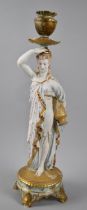 A Late 19th/Early 20th Century Continental Porcelain Figural Candlestick Depicting Water Carrier