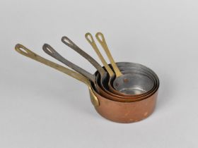 A Graduated Set of Five Miniature Copper Saucepans with Brass Handles, Largest 10cms Diameter