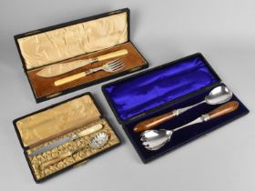 A Cased Wooden Handled Salad Server Set, A Cased Fish Knife and Fork Server Set and Berry Spoon