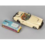 A Vintage Tinplate Friction Driven Sports Car Toy together with a Tinplate Childrens School Bus